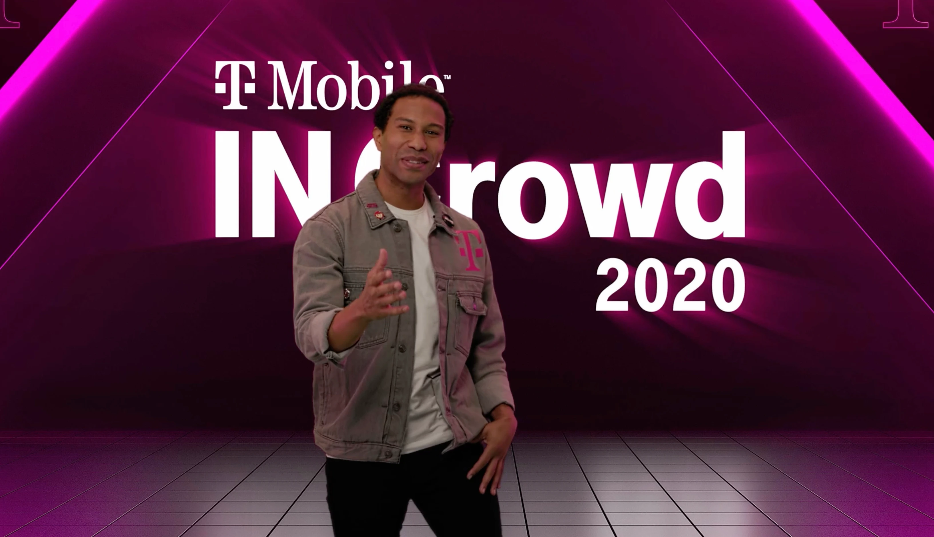 Host presenting the T-Mobile IN Crowd 2020 virtual broadcast on a magenta digital stage