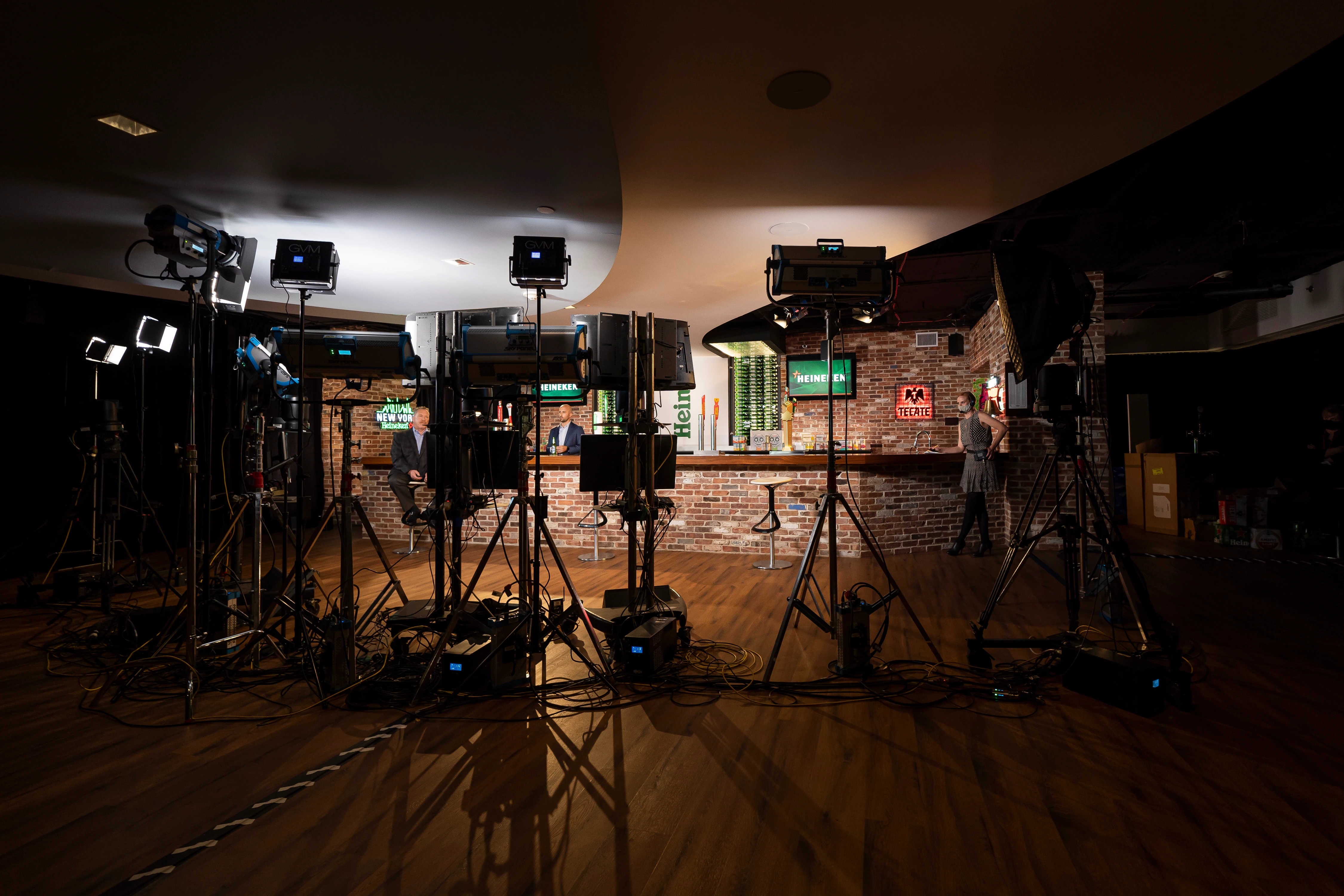 Camera rigs surround presenters at a bar set for the HEINEKEN virtual distributor meeting broadcast