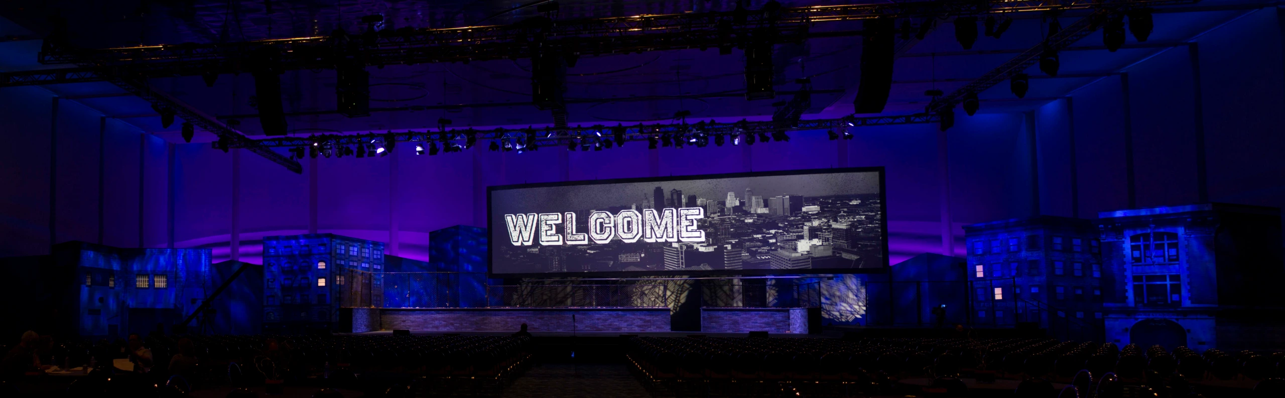 Blue-lit city block set framing the Welcome screen at the Harley-Davidson Street launch in Kansas City