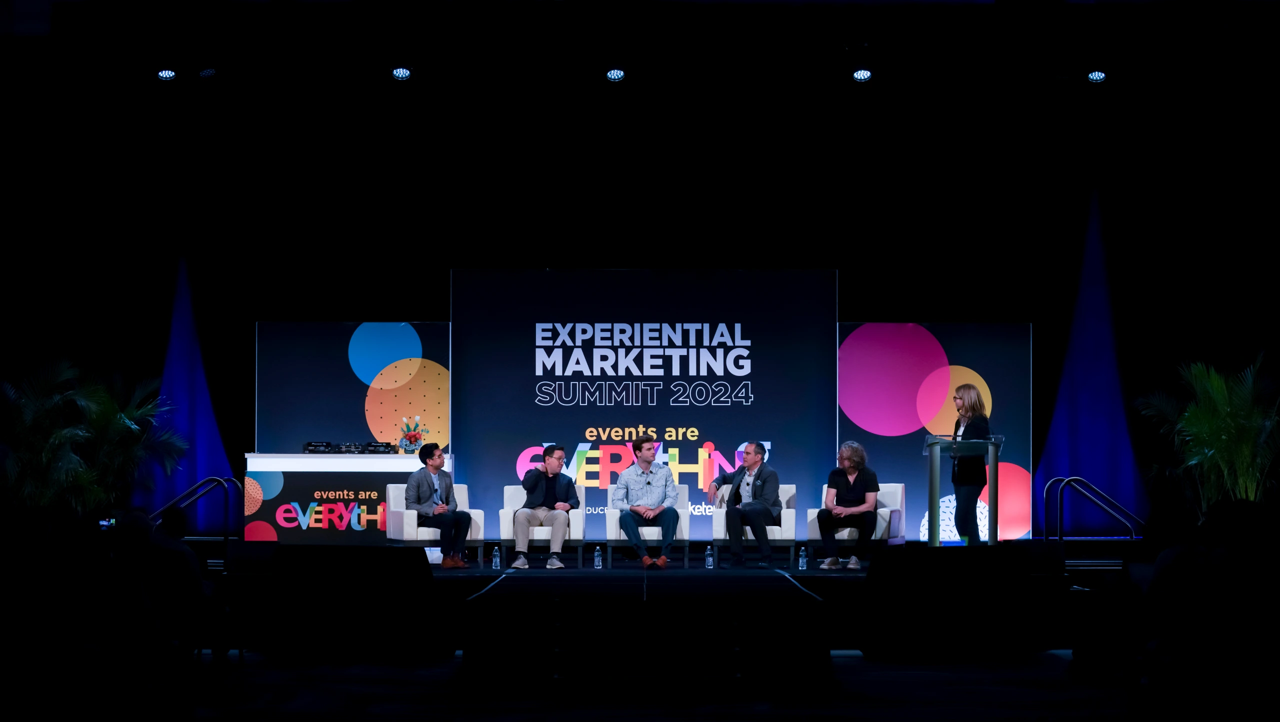 Panelists on the Experiential Marketing Summit 2024 stage with events are everything backdrop