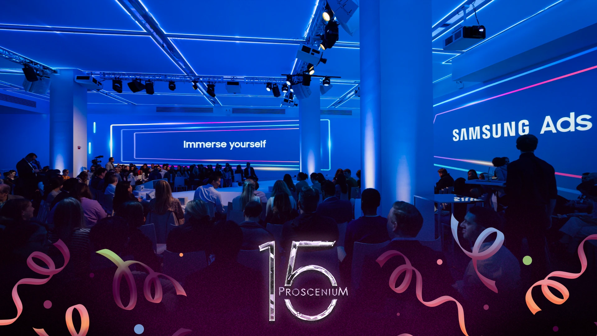 Samsung Ads Newfront audience in a blue-lit room facing an Immerse Yourself screen, with a Proscenium 15 mark
