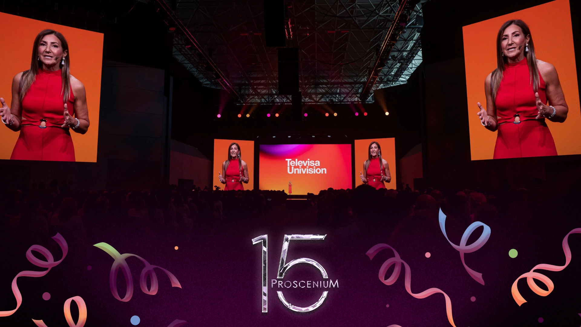 Speaker in red on the TelevisaUnivision Upfront stage, shown on giant side screens, with a Proscenium 15 mark