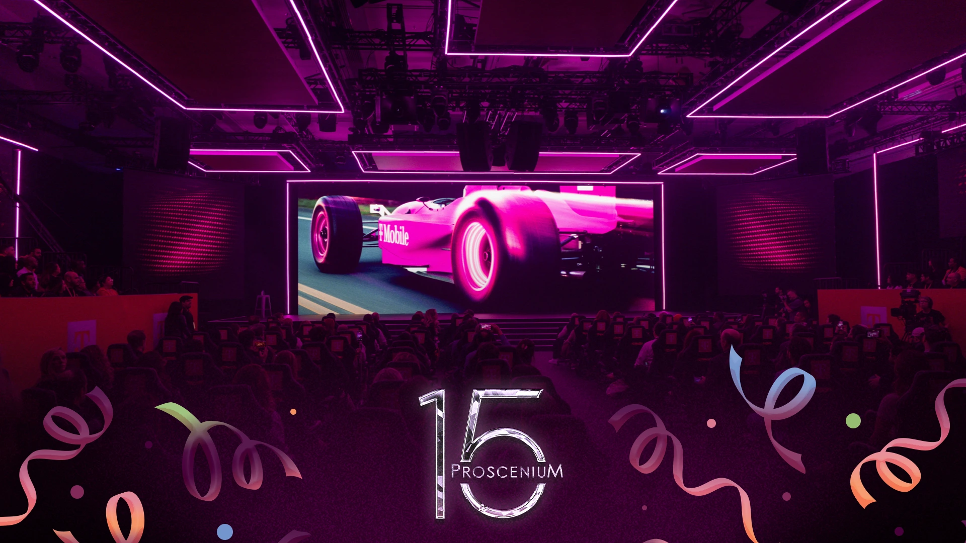 T-Mobile F1 theater with neon magenta trusses and a pink race car filling the screen, Proscenium 15 mark