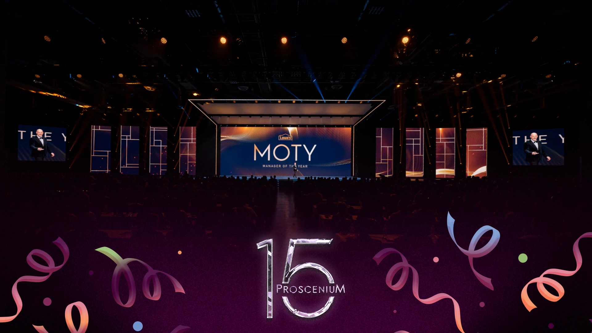 Lowe's Manager of the Year awards stage with MOTY on screen before a seated audience, Proscenium 15 mark