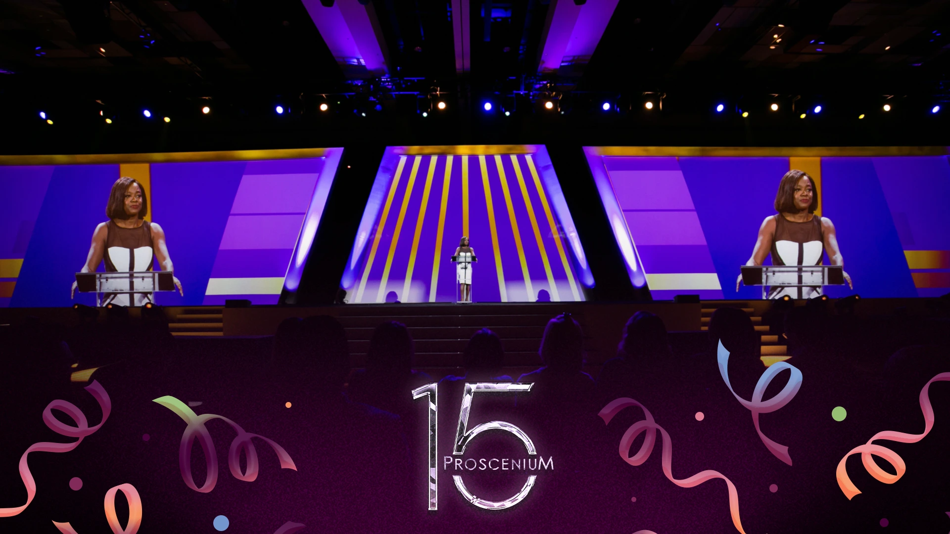 Viola Davis keynote on a purple and gold stage with her image mirrored on twin side screens